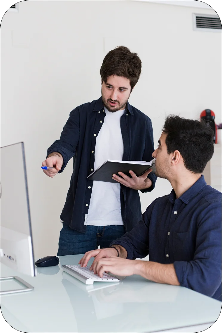 Man giving instructions to a colleague, reflecting a dedicated development team.